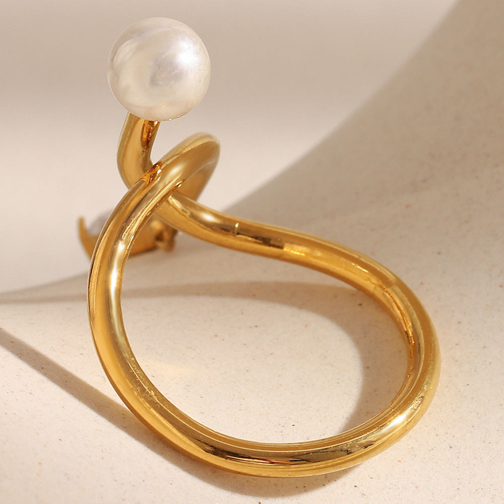 Anillo minimalista de acero inoxidable con chapado en oro de 18 quilates, detalle de nudo, acento de borla, circonita cúbica e incrustación de perlas de imitación