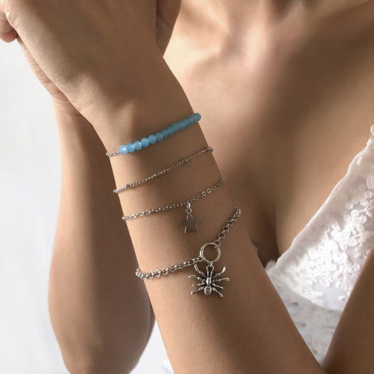 Bracciale multistrato punk "Sweet-Cool" con ragno geometrico e ciondoli a stella e croce in lega placcata