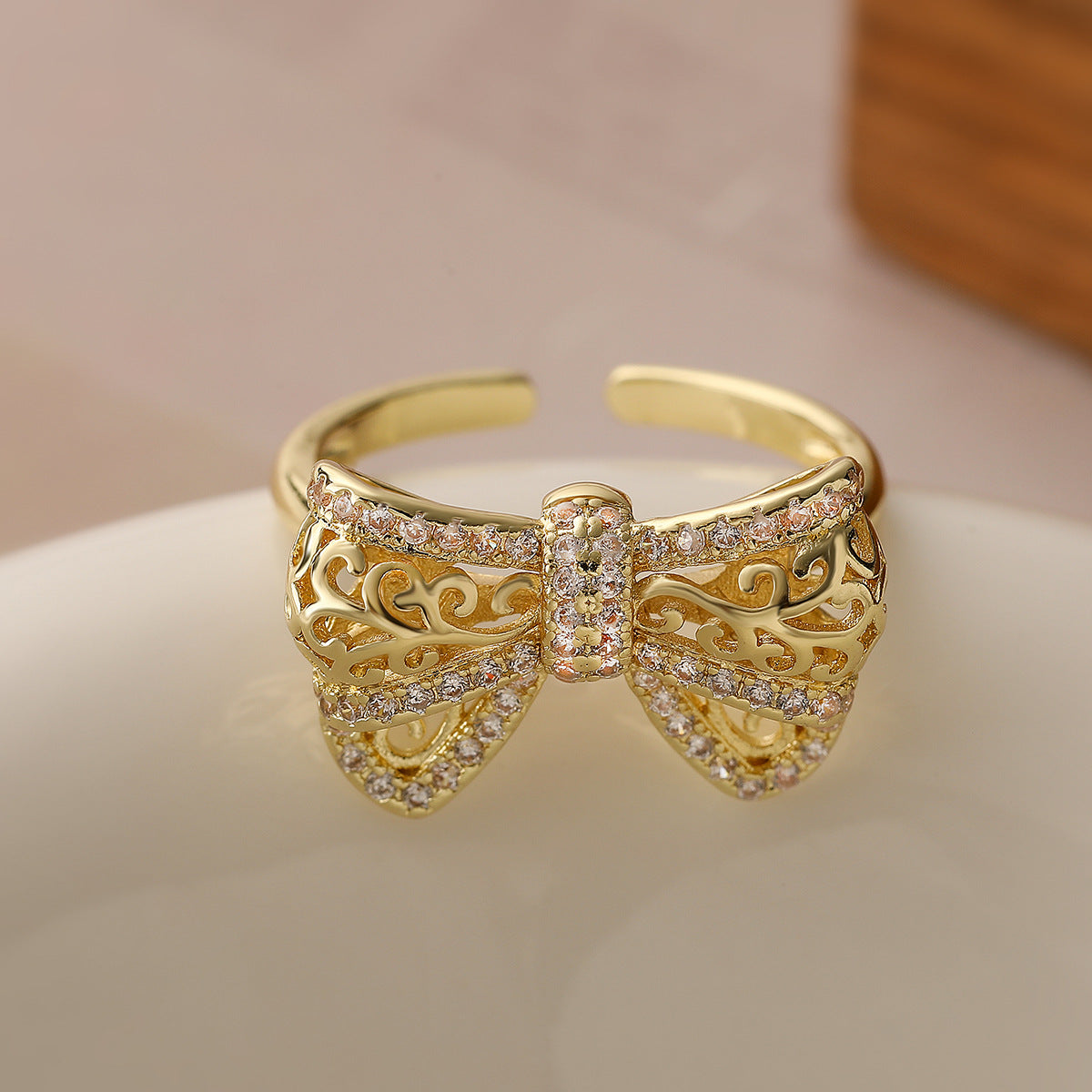 Minimalist Bowknot-Shaped Hollow-Out Copper Ring with 18K Gold Plating and Zircon Inlay for Women