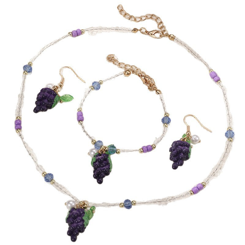 Set collana e braccialetto in lega con fiocco minimalista per ragazze con ciondoli a forma di ciliegia, uva, frutta e stella marina