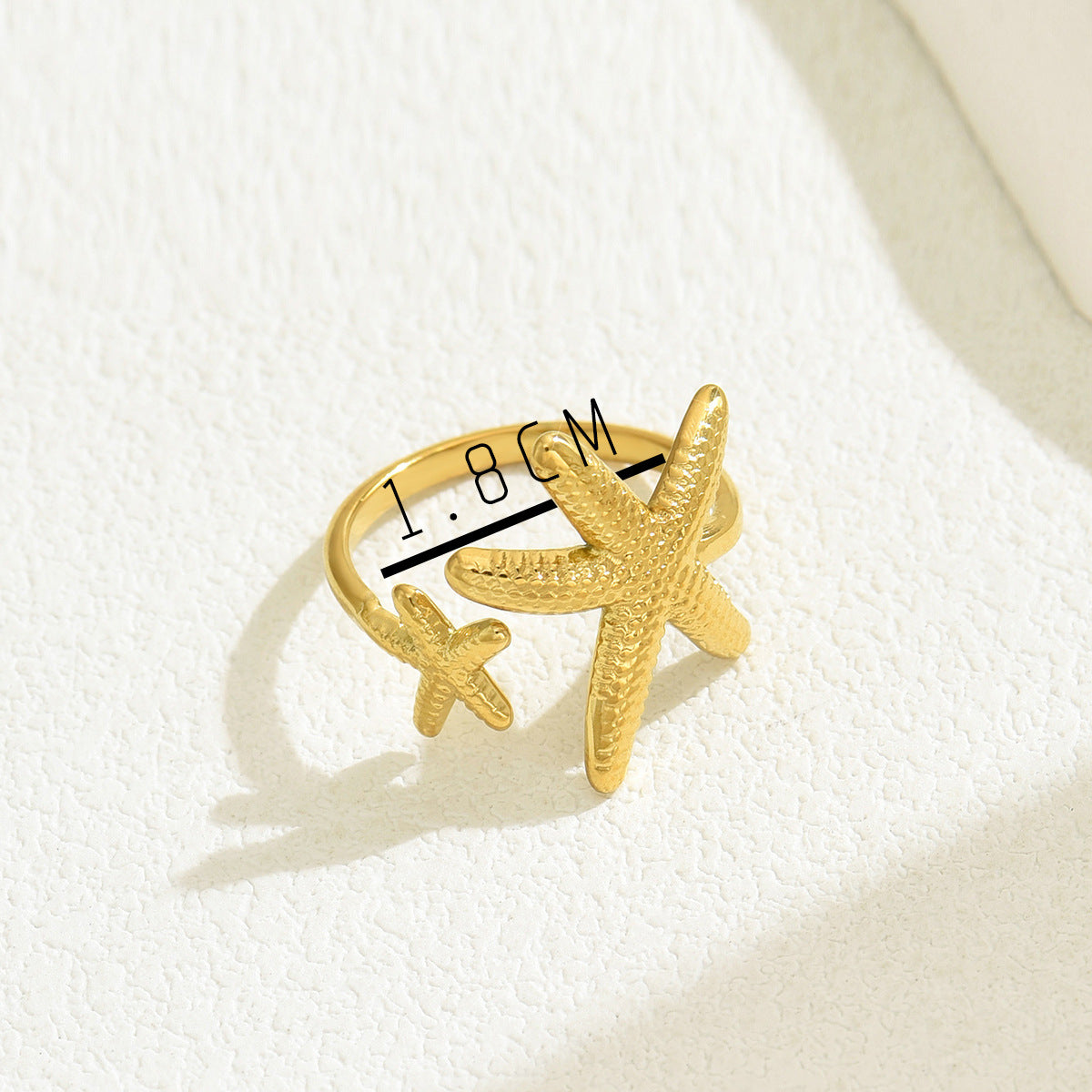 Anello da donna alla moda aperto a forma di stella marina in rame con finitura placcata