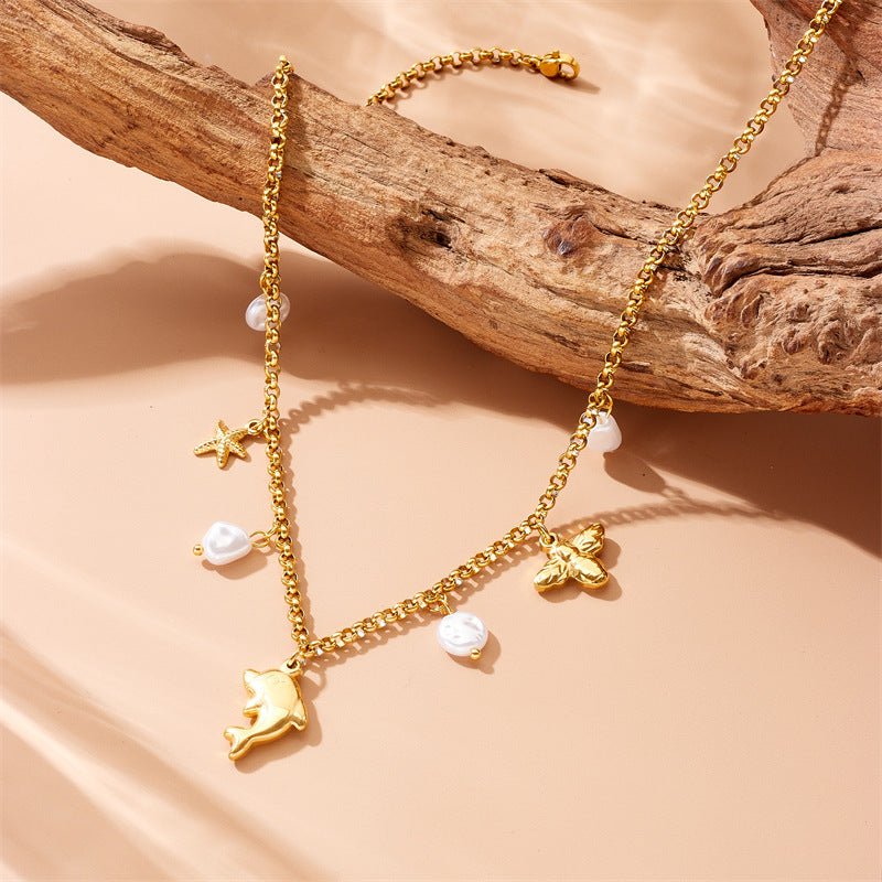 Collar con colgante de delfín, estrella de mar y perla, inspirado en el océano, de acero inoxidable, a la moda, para mujer, con cadena lateral