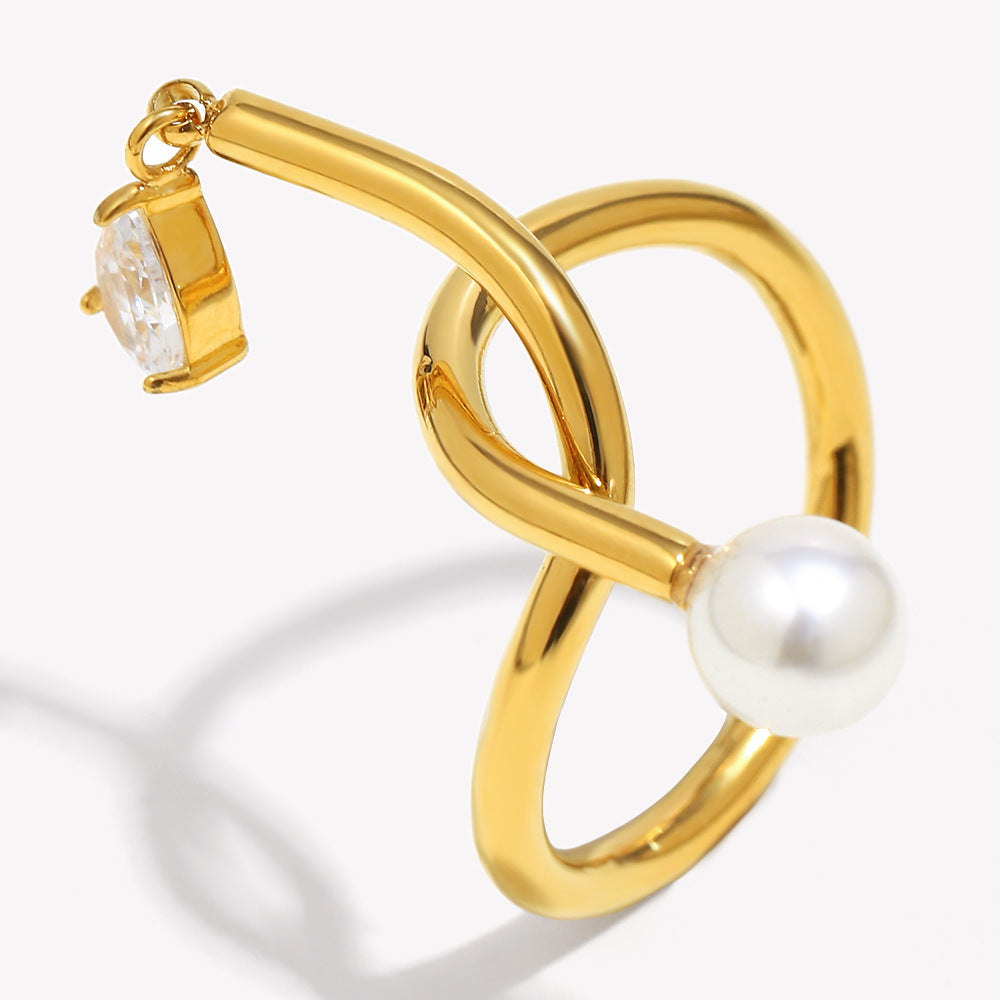 Anillo minimalista de acero inoxidable con chapado en oro de 18 quilates, detalle de nudo, acento de borla, circonita cúbica e incrustación de perlas de imitación