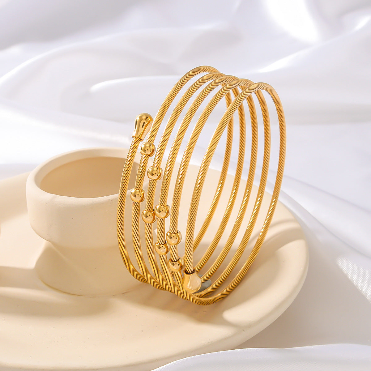 Bracciale da donna in acciaio inossidabile intrecciato a torsione irregolare stile Ins con finitura placcata