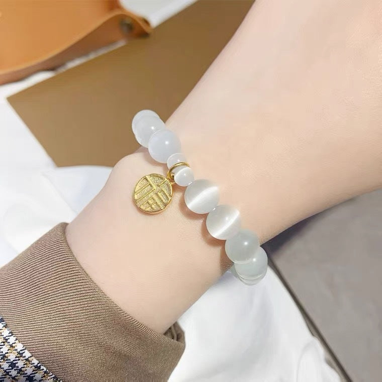 Bracciale da donna placcato in titanio e acciaio, con design floreale minimalista, pietra occhio di gatto e ciondolo portafortuna Fu