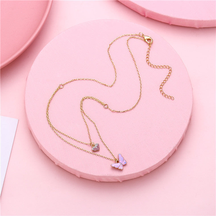 Collana con Ciondolo a Farfalla Minimalista Dolce per Ragazze in Lega Multistrato con Ciondolo a Cuore Smaltato Color Caramella e Catena a Croce