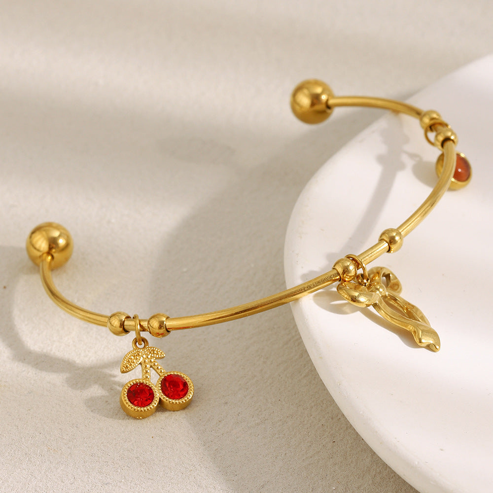 Elegant Fashionable Bowknot-Shaped Stainless Steel Plated 18K Gold C-Shaped Bracelet with Red Rhinestone Cherry Accent