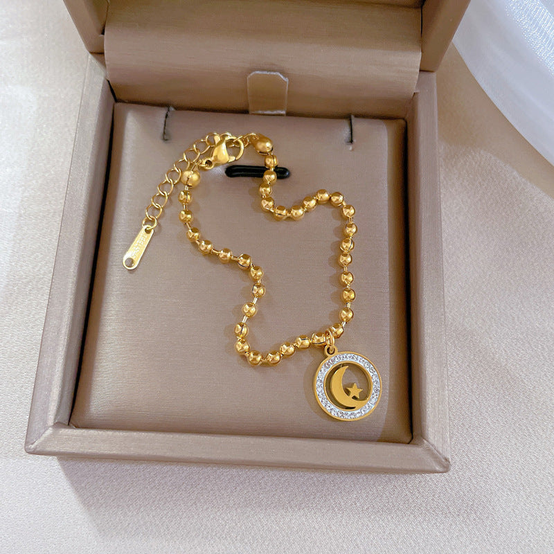 Bracciale Pendente Vintage Stella e Luna da Donna in Acciaio al Titanio Placcato Oro con Perline
