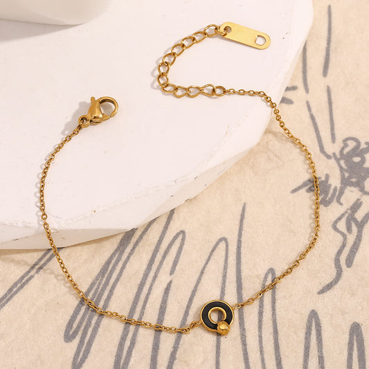 Bracciale da donna in acciaio inossidabile placcato oro 18 carati con simbolo rotondo in smalto nero, design geometrico e minimalista alla moda
