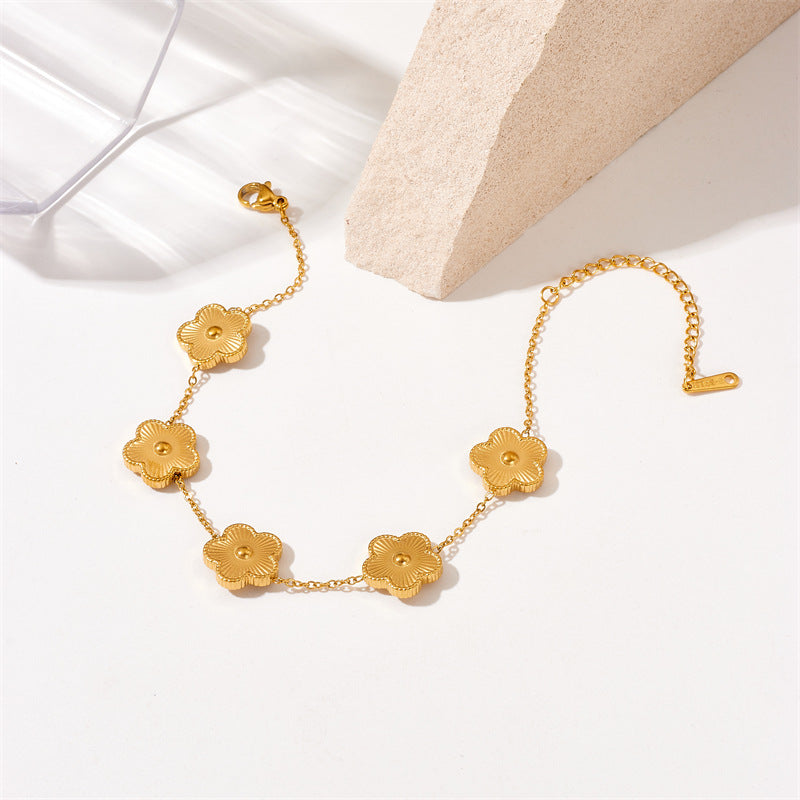 Bracciale da donna in acciaio al titanio placcato oro con motivo floreale alla moda