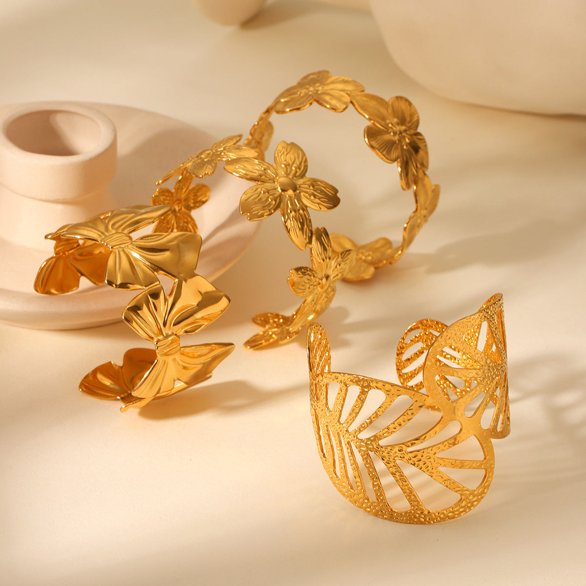 Trendy 18K Gold Plated Stainless Steel Open Cuff Bracelet with Hollow Leaf Flower Bowknot Design