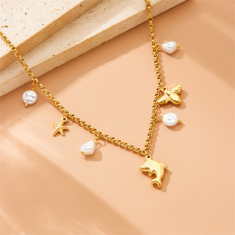 Collar con colgante de delfín, estrella de mar y perla, inspirado en el océano, de acero inoxidable, a la moda, para mujer, con cadena lateral