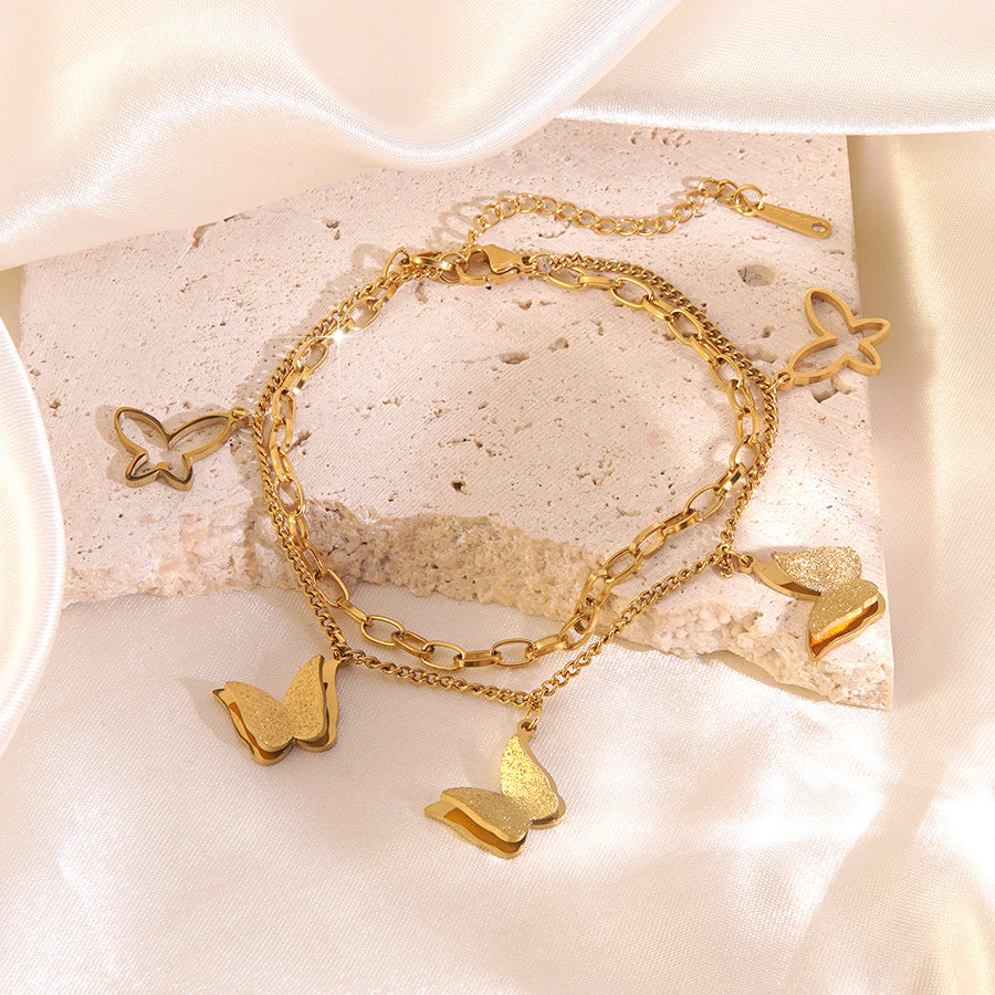 Bracciale a croce elegante a farfalla in acciaio inossidabile placcato oro con zirconi cubici da donna