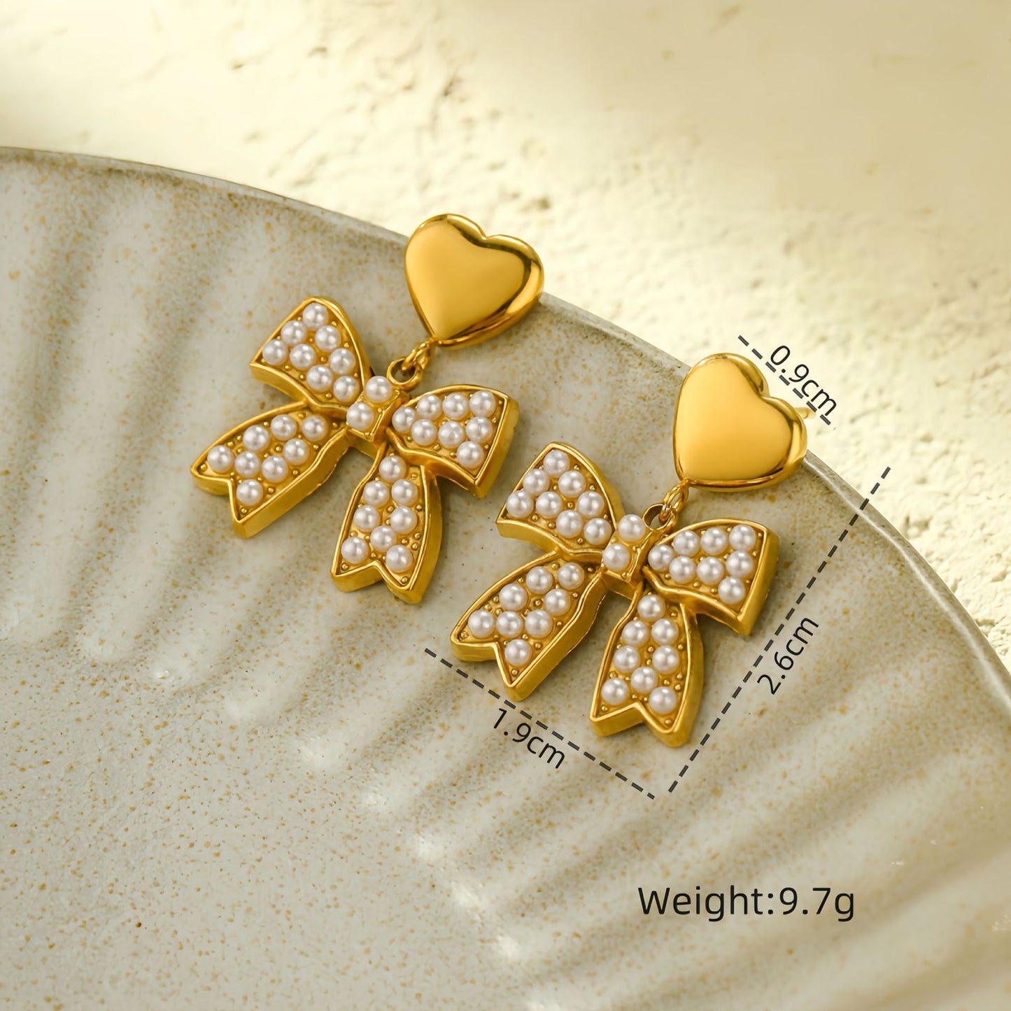 Pendientes elegantes de acero de titanio con lazo para mujer con detalles de pedrería, aretes de acero inoxidable en forma de corazón, minimalistas y versátiles