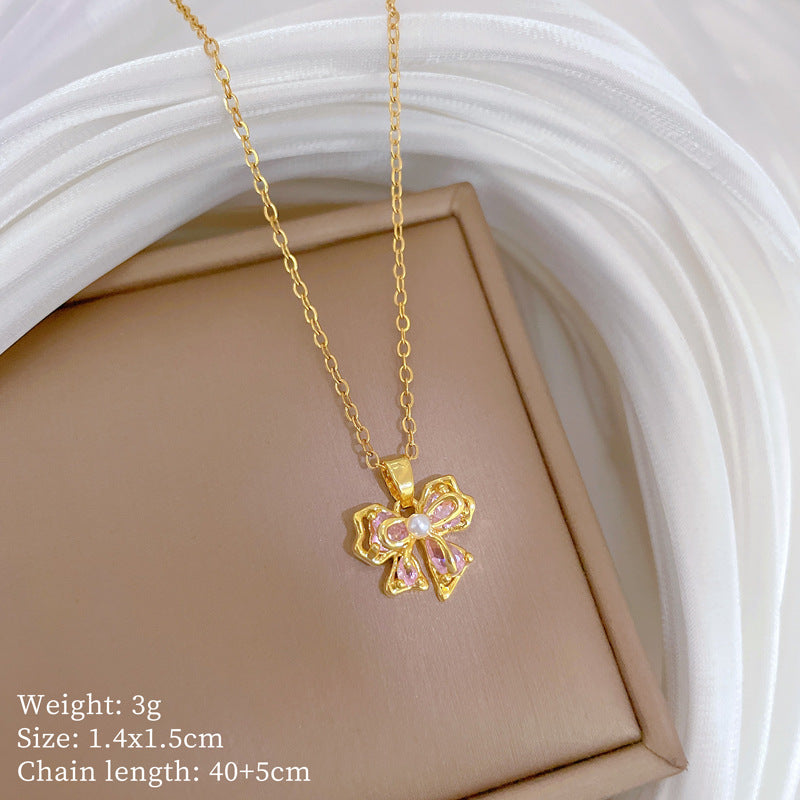 Collana con ciondolo a fiocco rosa con strass da donna in acciaio al titanio con delicata catena a medaglione