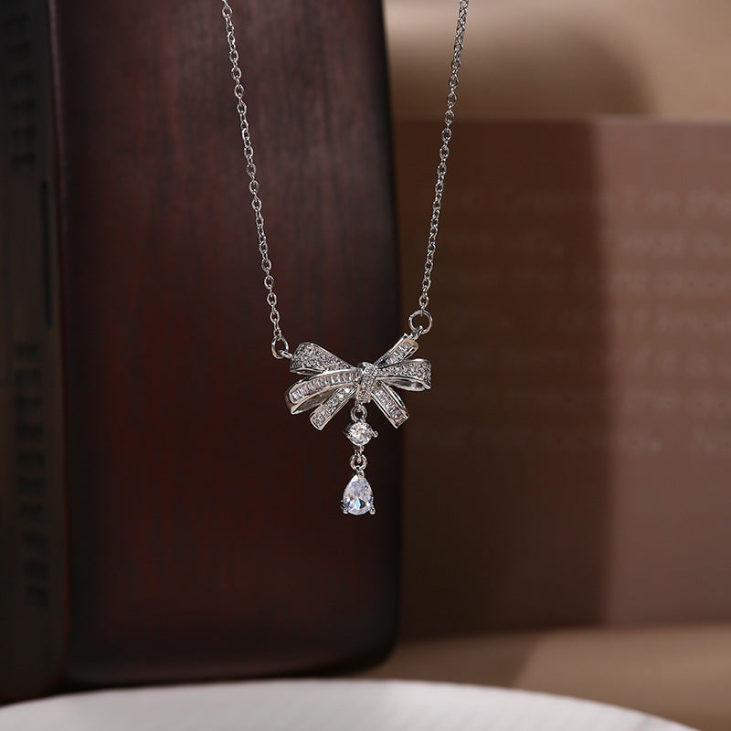 Sweet and Edgy Bow-Shaped Titanium Steel Necklace with Rhinestone Inlay for Women and Men
