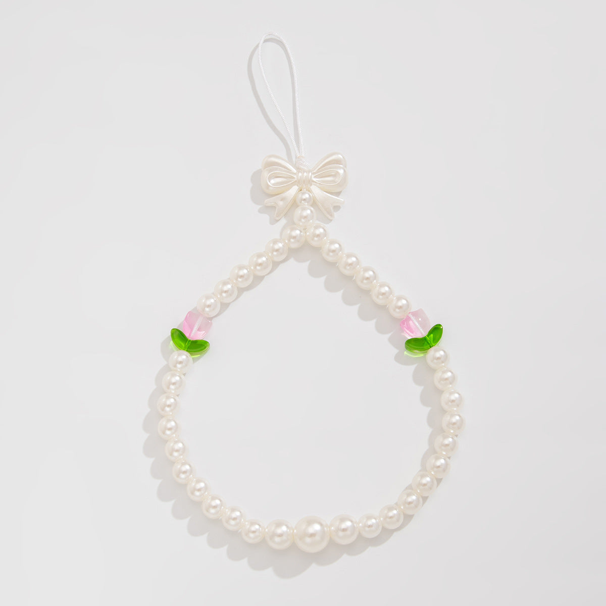Bonita correa de teléfono con nudo de lazo de tulipán y perlas de imitación para mujeres, accesorio tejido a mano con dulce estilo floral