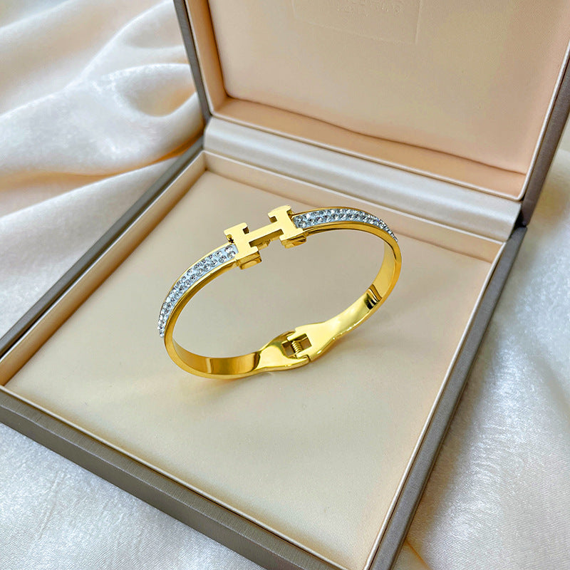 Bracciale minimalista in titanio e acciaio placcato oro rosa con intarsio in strass e design dalla forma irregolare