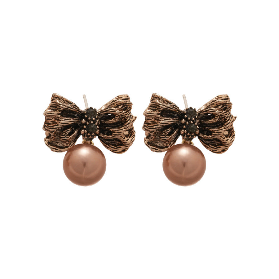 Pendientes de aleación con forma de lazo Retro Chic con detalles de perlas y baño de oro para mujer