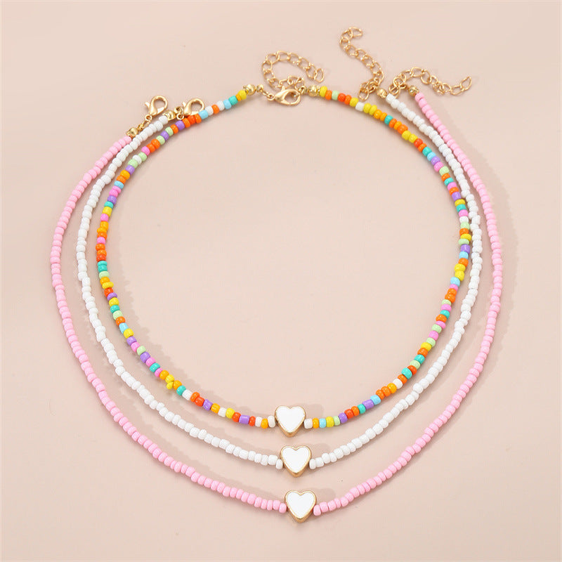 Collar artesanal bohemio con cuentas de cristal blancas en forma de corazón para niños