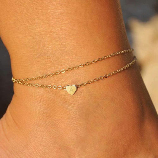 Tobillera minimalista de acero de titanio chapada en oro de 18 quilates con corazón geométrico para mujer