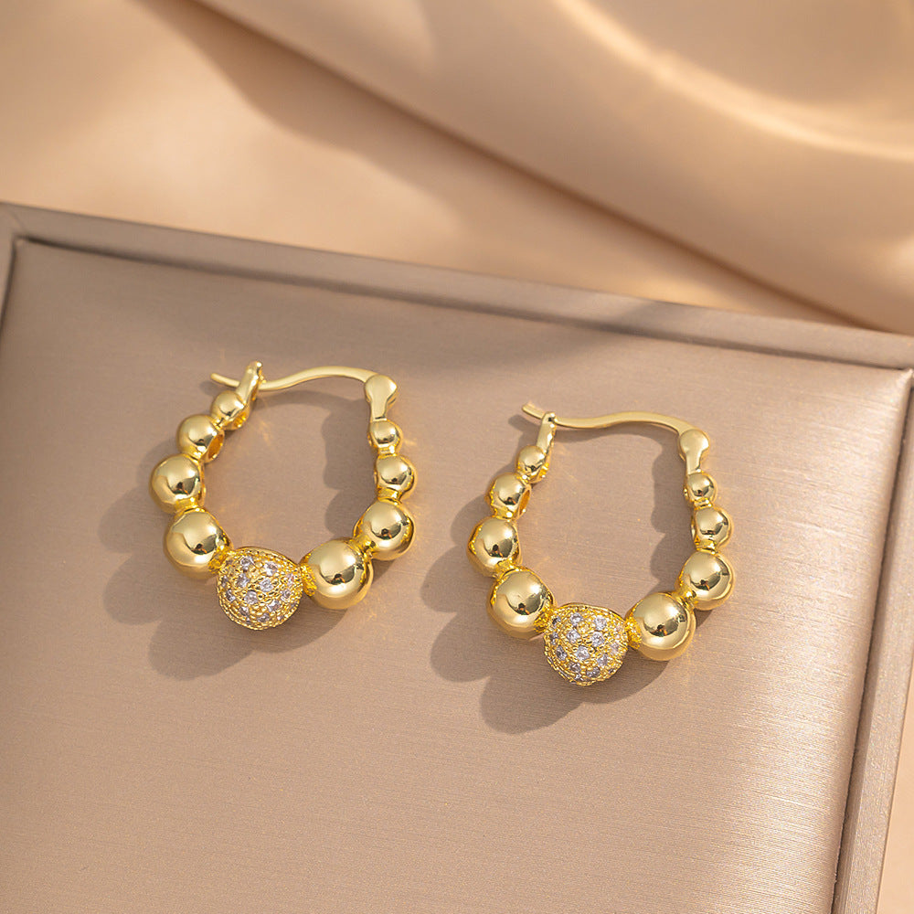 Orecchini a perno Saturno minimalisti color oro in ottone con zirconi per donna