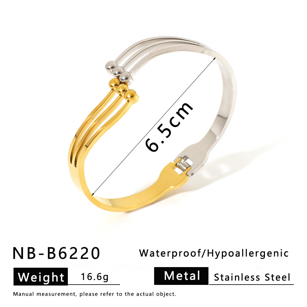 Minimalist Asymmetrical Stainless Steel Bracelet with Gold Plating Featuring Floral and Star Motifs and Linear Design