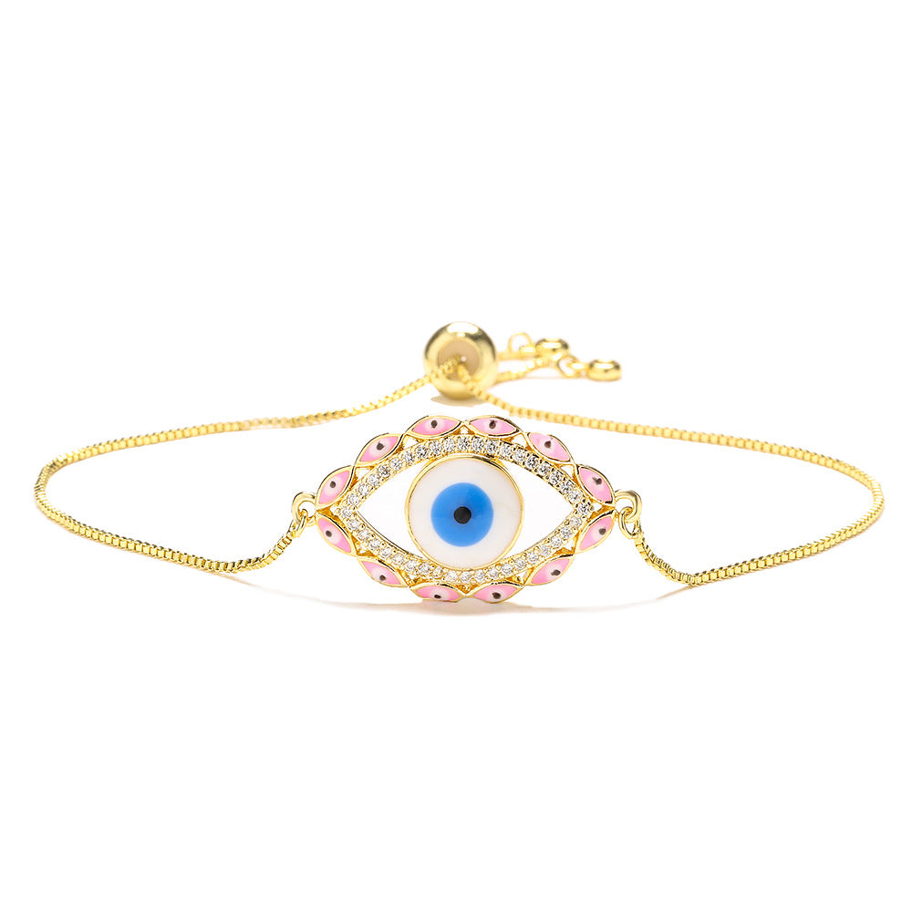 Bracciale da donna stile bohémien con charm a forma di occhio di Nazar, base in rame placcata in vero oro e intarsio di zirconi