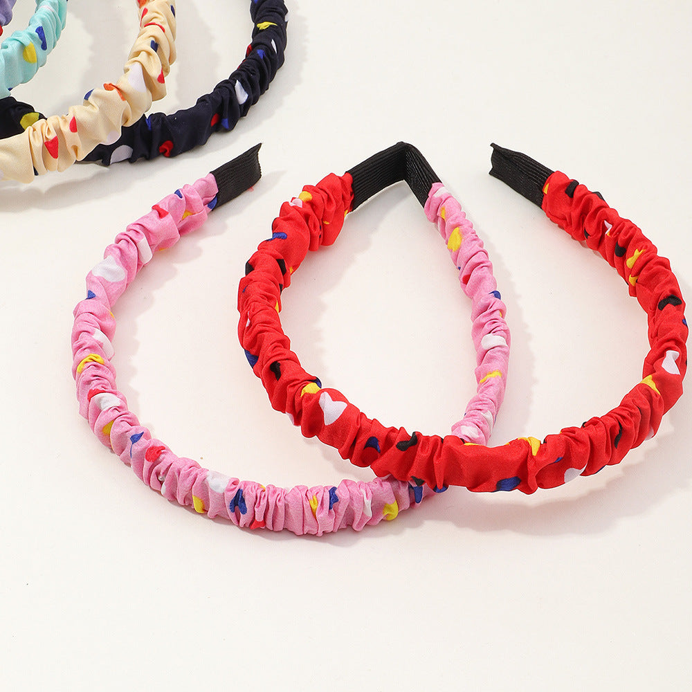 Bonita diadema de resina plástica con estampado de corazones para niños con acabado artesanal en forma geométrica