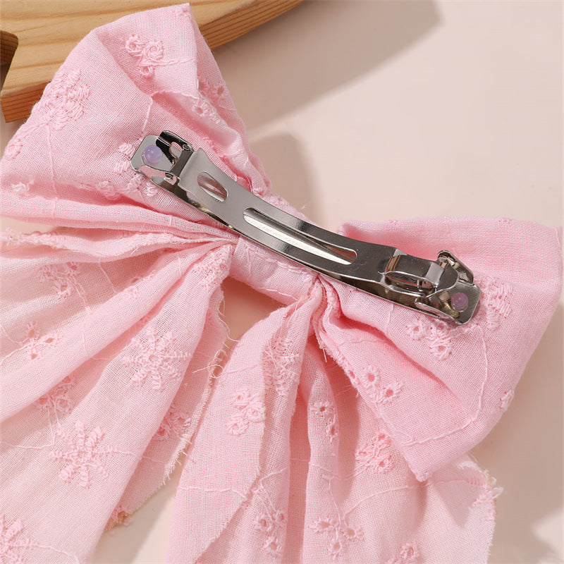 Graziosa molletta per capelli rosa a forma di fiocco per bambine con dettagli a volant e in rete, realizzata in resina plastica con chiusura a molla