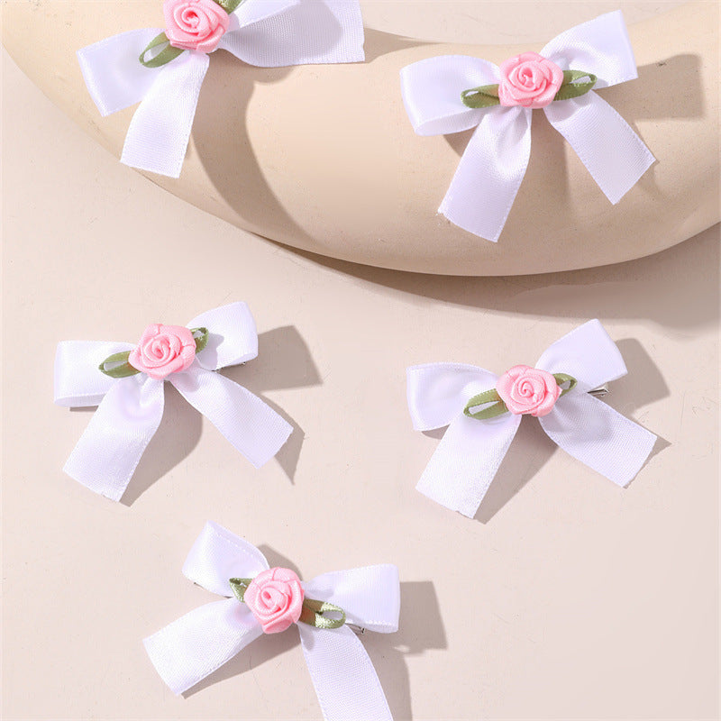 Juego de pinzas para el pelo con forma de lazo estilo dulce para niños con motivos florales y de rosas en rosa y morado sobre fondo de hojas verdes