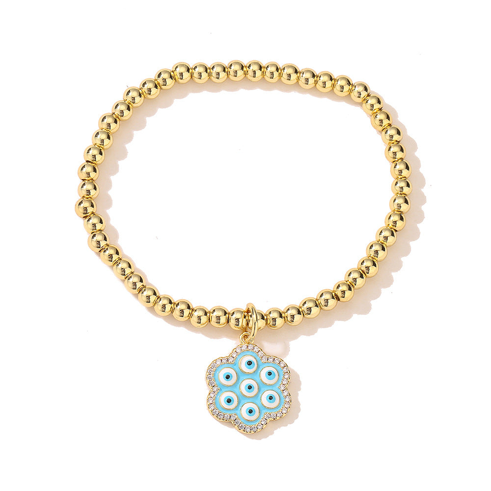 Bracciale geometrico in rame stile INS con placcatura in oro 18K, intarsio di strass e dettaglio occhio blu smaltato