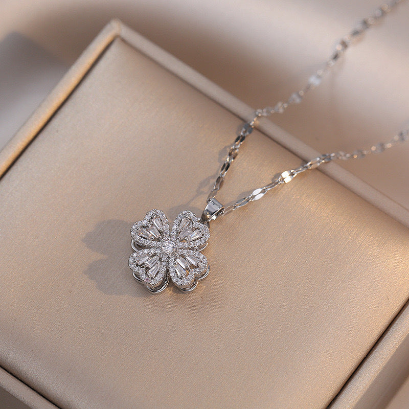 Collana con ciondolo a quadrifoglio rotante da donna in acciaio al titanio con zirconi bianchi micro-incastonati e placcatura in oro su catena ondulata