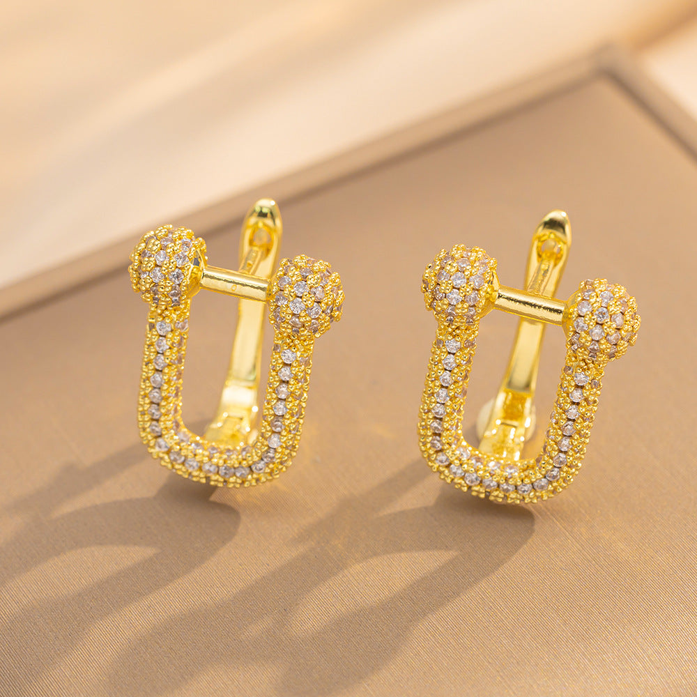 Orecchini a perno Saturno minimalisti color oro in ottone con zirconi per donna