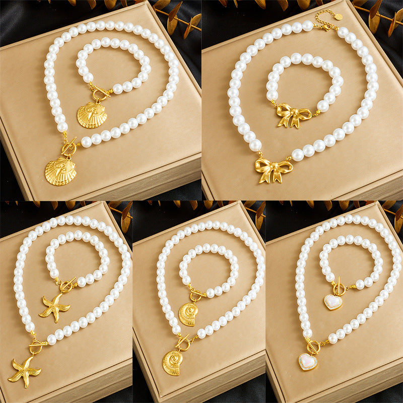 Conjunto de collar y pulsera de acero inoxidable chapado en oro con cadena de perlas vintage francés, broche OT, vieira y estrella de mar