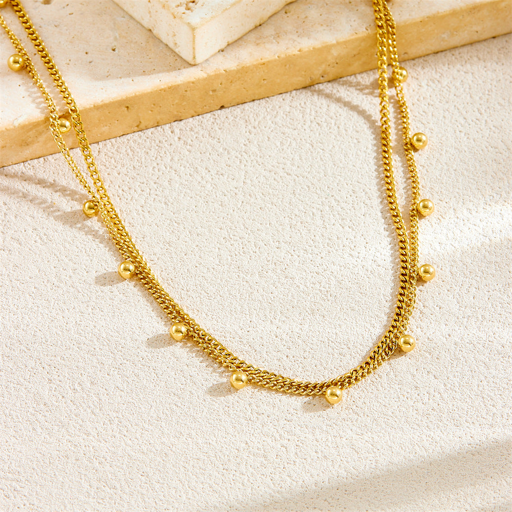 Collana da donna a doppio strato con perline rotonde in acciaio inossidabile placcato oro, stile minimalista