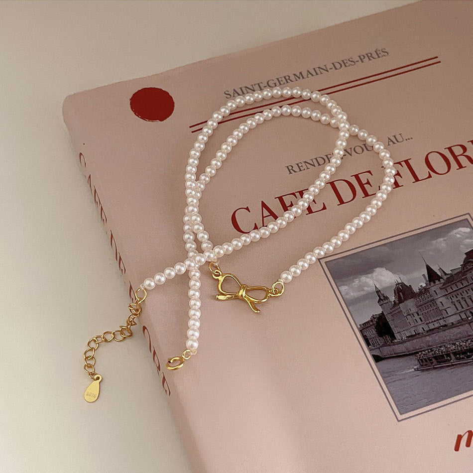Minimalist Bowknot Pendant Necklace in 925 Sterling Silver with Rhinestone and Pearl Accents on Cross Chain