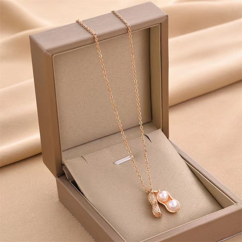Collar con colgante minimalista de acero de titanio con forma de cacahuete y circonitas para mujer