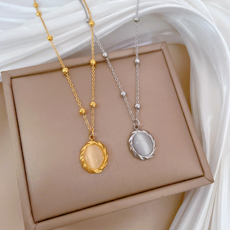 Collana girocollo da donna con ciondolo in pietra occhio di gatto girevole in acciaio inossidabile placcato oro dal design geometrico minimalista