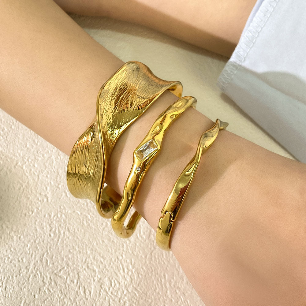 Geometric Twisted Wave Stainless Steel Bracelet with Rhinestone Accents and Polished Finish