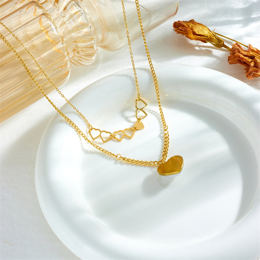 Collana alla moda con ciondolo a doppio strato a forma di cuore cavo in acciaio al titanio con finitura placcata per donna