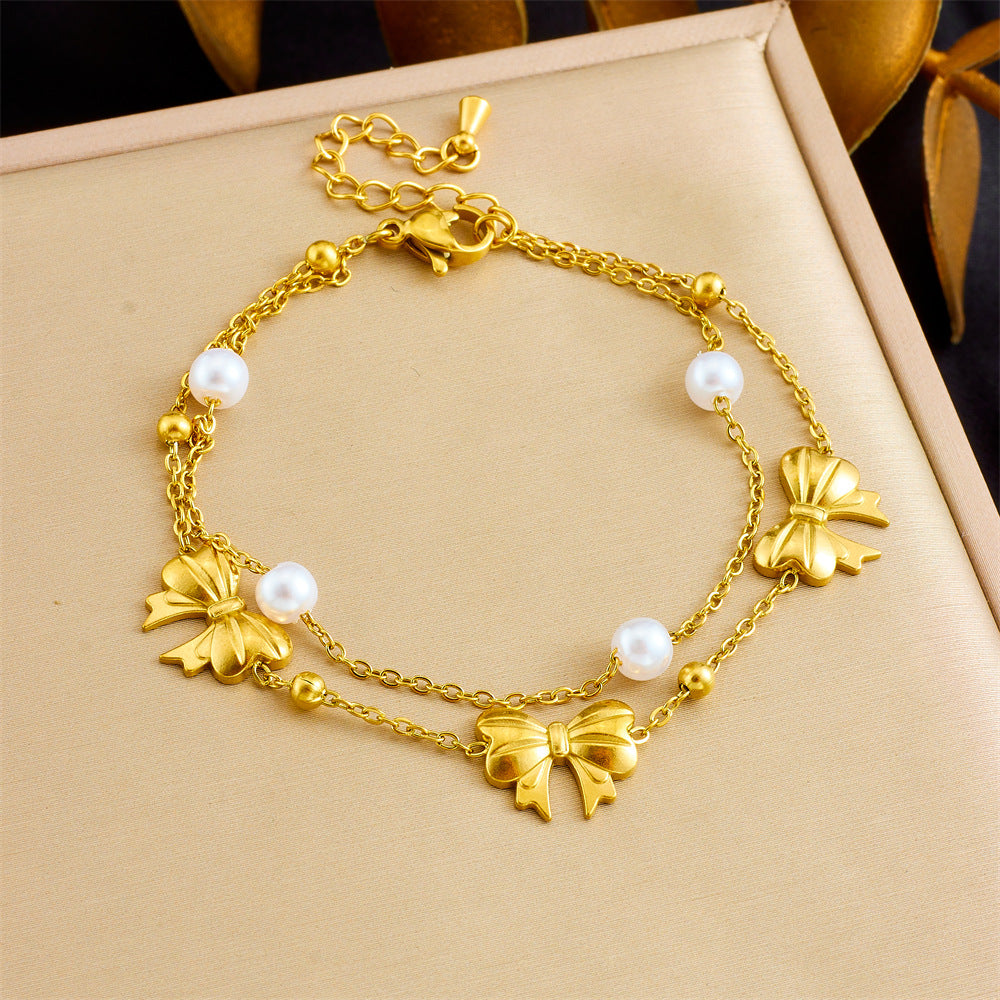 Bracciale minimalista da donna in acciaio inossidabile a forma di fiocco con placcatura in oro e inserti di perle