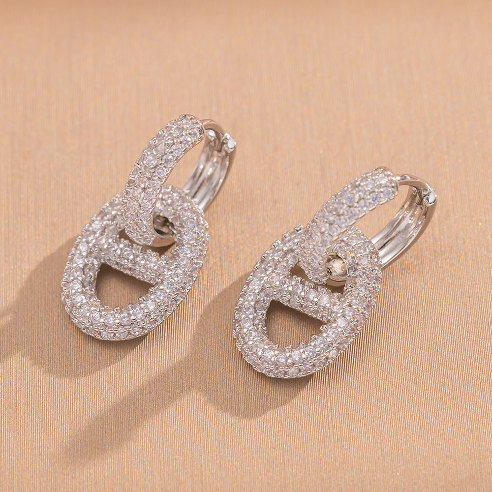 Orecchini a perno Saturno minimalisti color oro in ottone con zirconi per donna