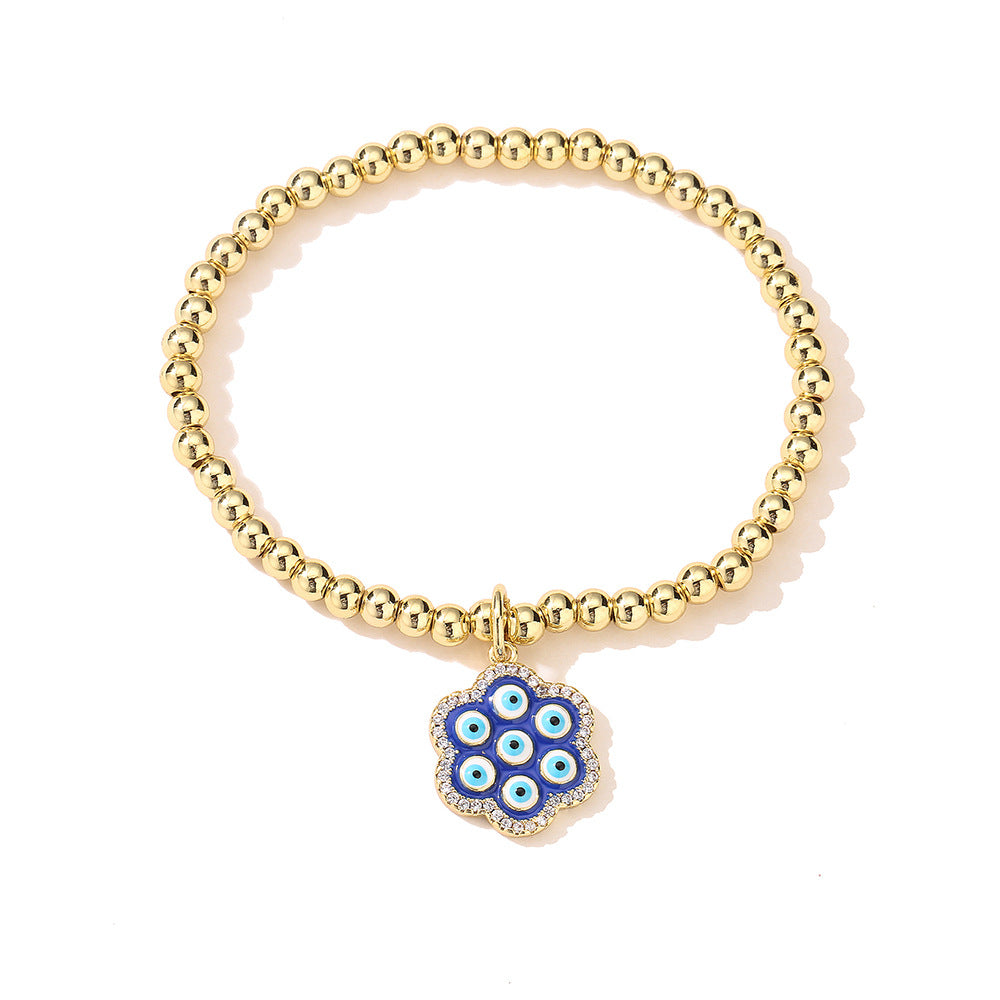 Bracciale geometrico in rame stile INS con placcatura in oro 18K, intarsio di strass e dettaglio occhio blu smaltato