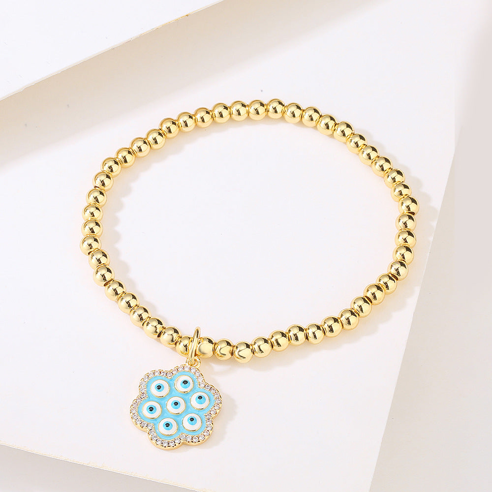 Bracciale geometrico in rame stile INS con placcatura in oro 18K, intarsio di strass e dettaglio occhio blu smaltato