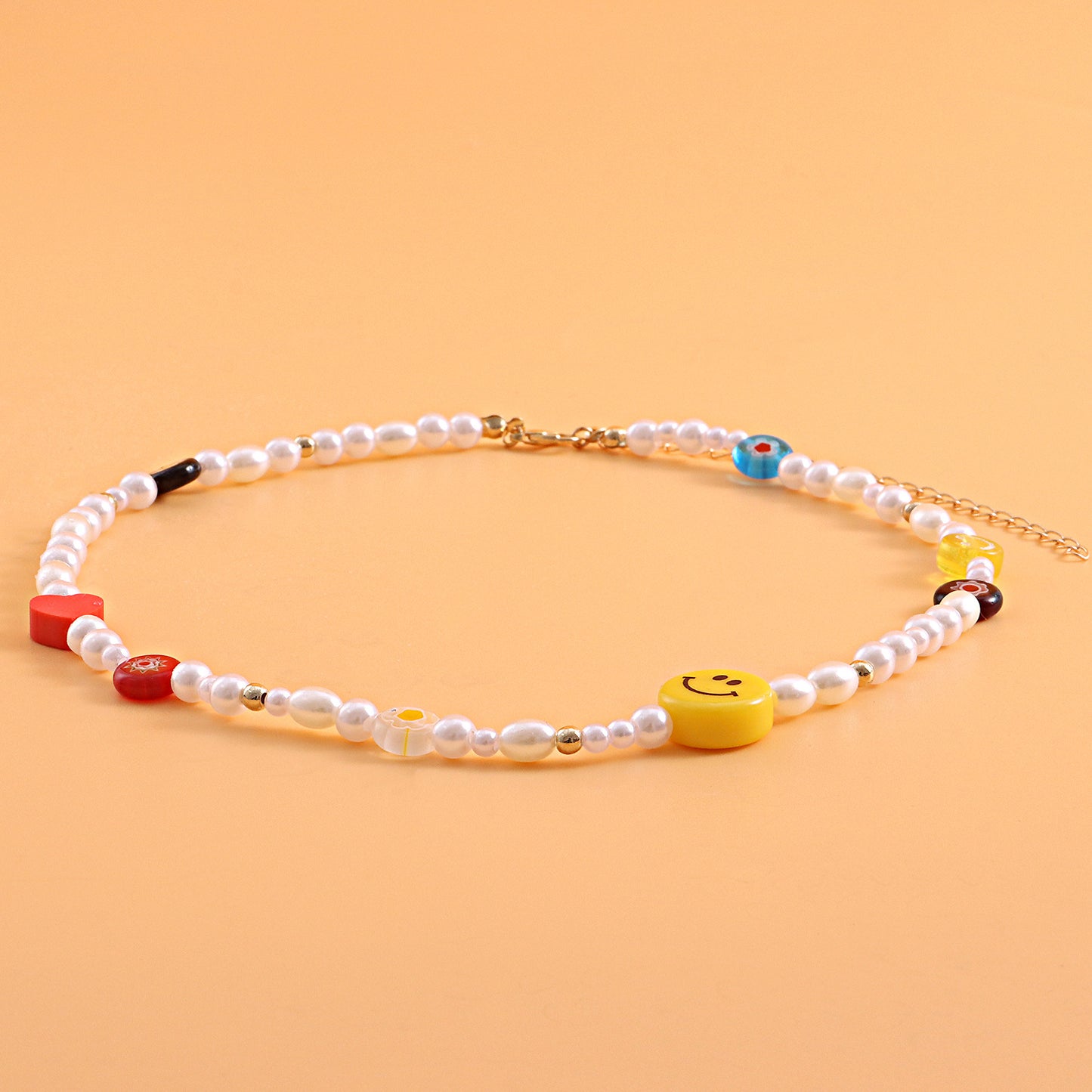 Yellow Smiley Face Acrylic Necklace with Red Heart-Shaped Polymer Clay and Glass Flower Pendant on Clear Fishing Line Chain