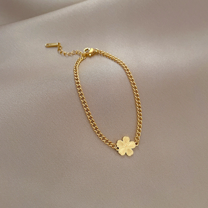 Minimalist Titanium Steel Five-Petal Flower Hand Chain for Women with Gold Plating and Wavy Texture Design