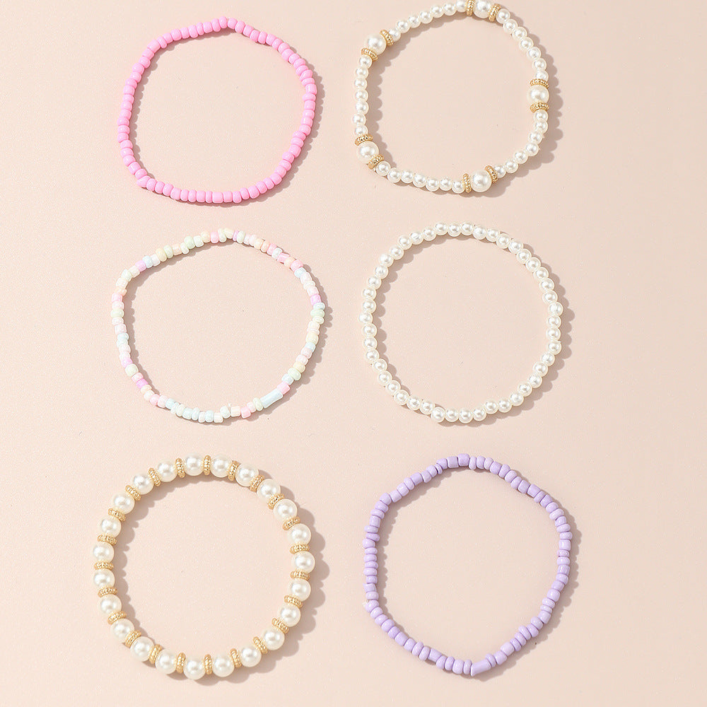 Set de pulseras de cuentas de cristal geométricas minimalistas para niñas en colores pastel rosa y morado