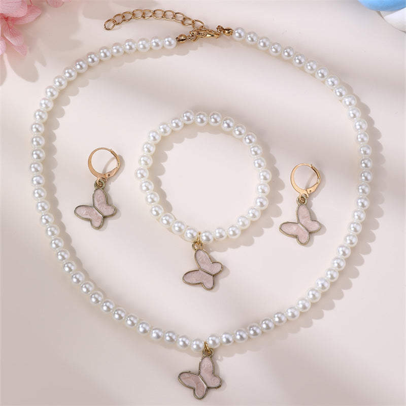 Conjunto Minimalista de Collar con Forma de Lazo de Aleación para Niñas con Detalles de Perlas, Incluye Pulsera, Anillo y Pendientes de Botón