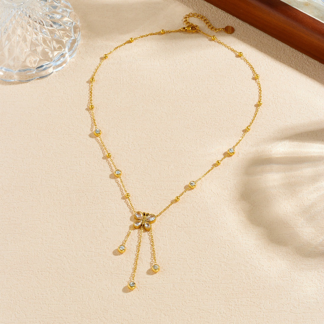 Minimalist Gold Plated Stainless Steel Butterfly Teardrop Pendant Necklace with Rhinestone Inlay and Tassel Chain for Women
